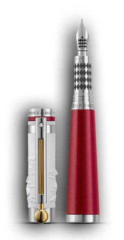 Das Bild zeigt einen Füllfederhalter der Marke Montegrappa. Er stellt die limitierte Ausgabe von Prinz Albert II von Monaco (mittlerweile Fürst Albert) für seine Organisation Life da. Die Kappe ist zylindrisch in mattweiß und stellt 3D herausgearbeitet eine Eisbärenmutter mit ihren Jungen da. Der Kopf der Kappe ist Silber mit einem matt-roten Ring aus Aluminium darunter. Der Clip ist aus Silber und Gold und umschließt die Kappe mit einem silbernen Ring. Der Griffkorpus ist aus matt-rotem Aluminium und geht zur Feder hin in einen silbernen Part über, der mit schwarzen Karos umlaufend versehen ist. Die Karos finden sich auch auf der Federoberseite wieder. Der Fuß des Korpus ist aus einem silbernen Ring. Die Besonderheit des Griffstücks liegt in seiner Form die konisch zur Feder hin laufend ist. Das Design stammt von Marco Colasanti. Weitere Informationen zu diesem Füllfederhalter bekommen Sie beim anwählen dieses Bildes auf der Homepage von Montegrappa.